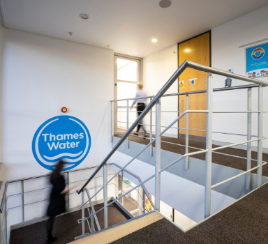 two people walk around the office at walnut court