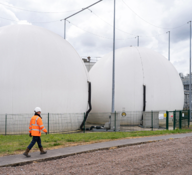 a colleague walks past gas bags at a sewage treatment works site