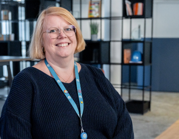 a colleague smiles for a photograph