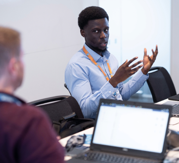 two colleagues have a conversation in a meeting