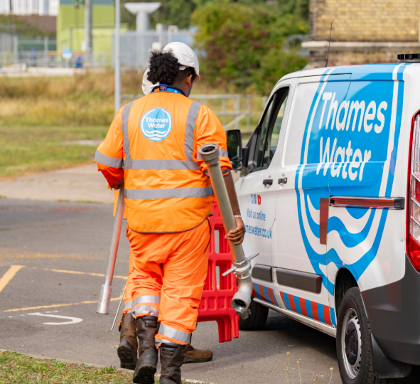 a network service technician walking towards a Thames Water van