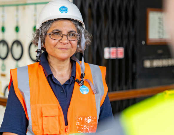 A colleague smiles in conversation