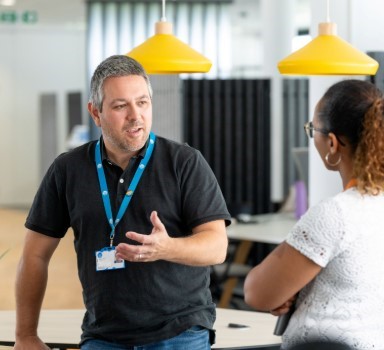 Two Thames Water colleagues having a conversation in the office