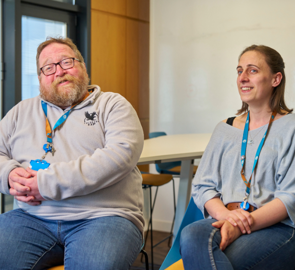 Two Thames Water colleagues smile in conversation