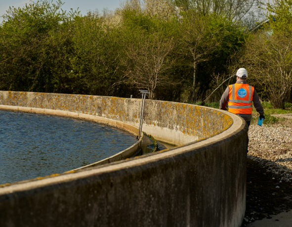 A Thames Water colleagues walks around a sewage treatment works site