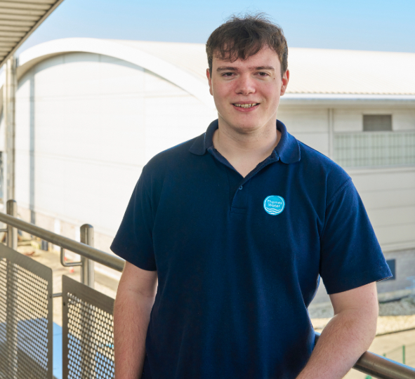A Thames Water colleague smiles at the camera