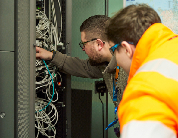 Two Thames Water colleague inspect operational technology